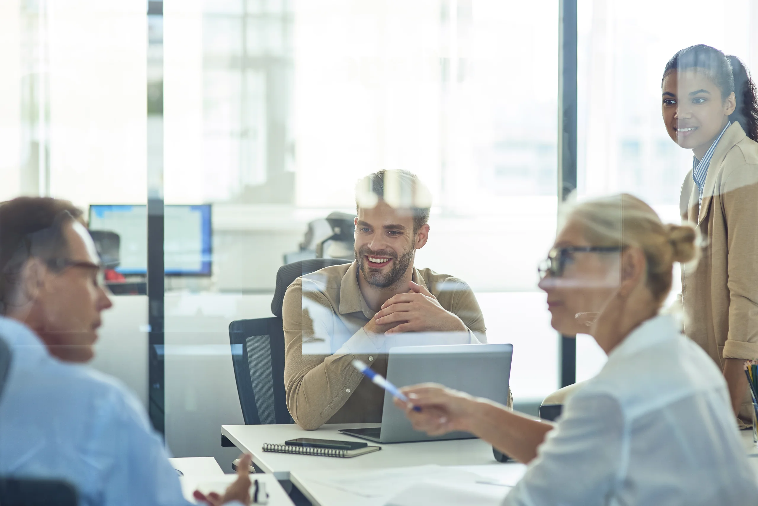 group of multiracial business people sitting in board room in the modern office and discussing something while having a meeting group of multiracial business people sitting in board room in the modern office and discussing something while having a meeting
